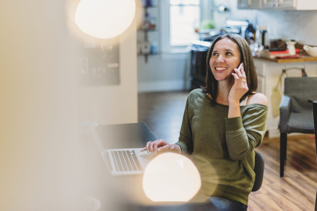 Johanna Voss, fractional COO for talent management agencies, on a call with laptop open at her home office